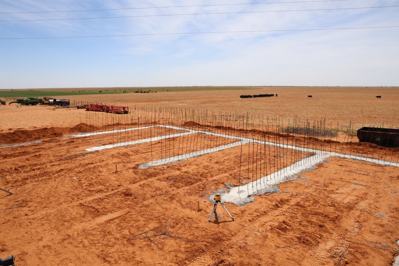 Crew working on concrete stem walls with safety vests on a commercial job site